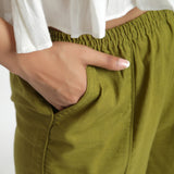 Front Detail of a Model wearing Olive Green Cotton Mid-Rise Elasticated Wide Legged Pant
