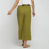 Back View of a Model wearing Olive Green Cotton Mid-Rise Elasticated Wide Legged Pant
