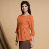 Left View of a Model wearing Orange Yarn Dyed Cotton Pleated High-Low Top