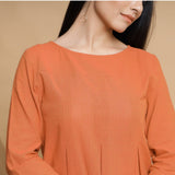 Front Detail of a Model wearing Orange Yarn Dyed Cotton Pleated High-Low Top