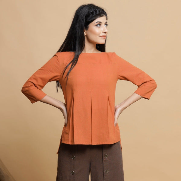 Front View of a Model wearing Orange Yarn Dyed Cotton Pleated High-Low Top
