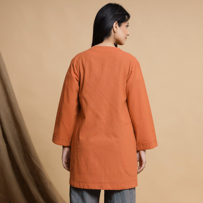 Back View of a Model wearing Orange Cotton High Neck Double Placket Coat