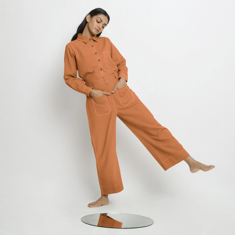 Front View of a Model wearing Orange Button-Down Top and Rust Pant Set