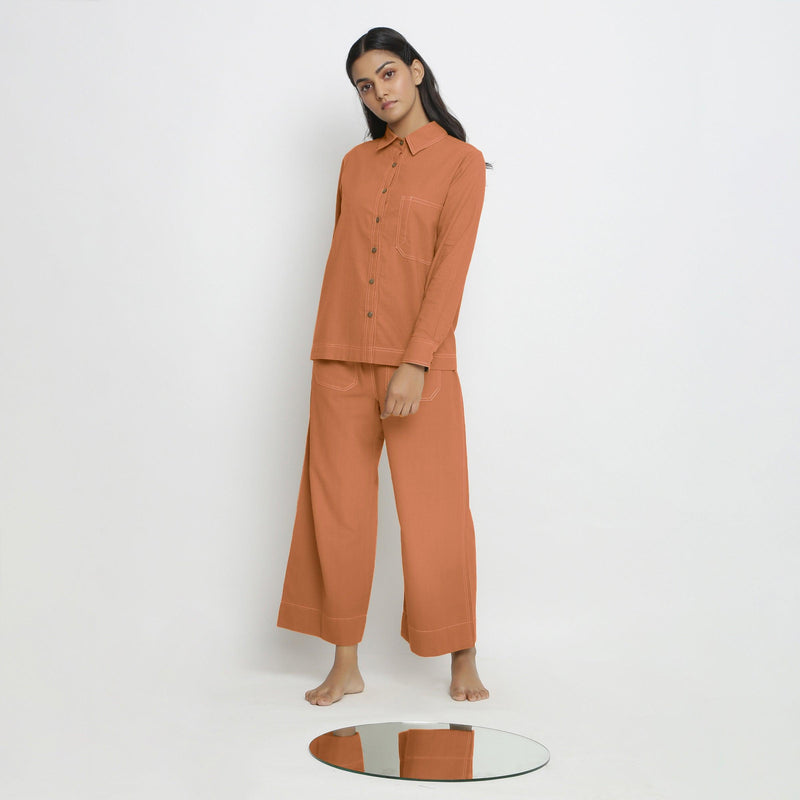 Front View of a Model wearing Orange Button-Down Top and Rust Pant Set