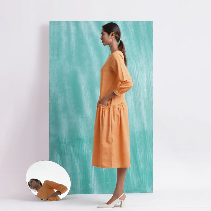 Left View of a Model wearing Orange Comfort Fit Mirror Work Dress