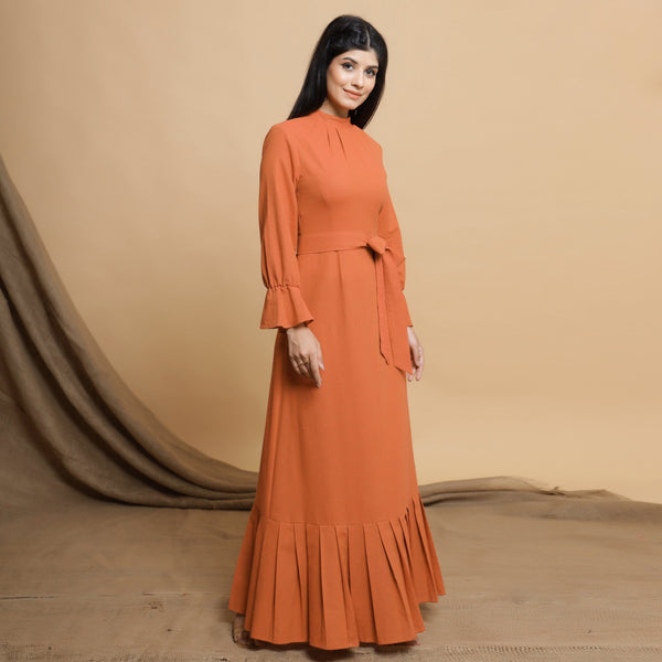 Right View of a Model wearing Orange Floor Length Pleated Tier Dress