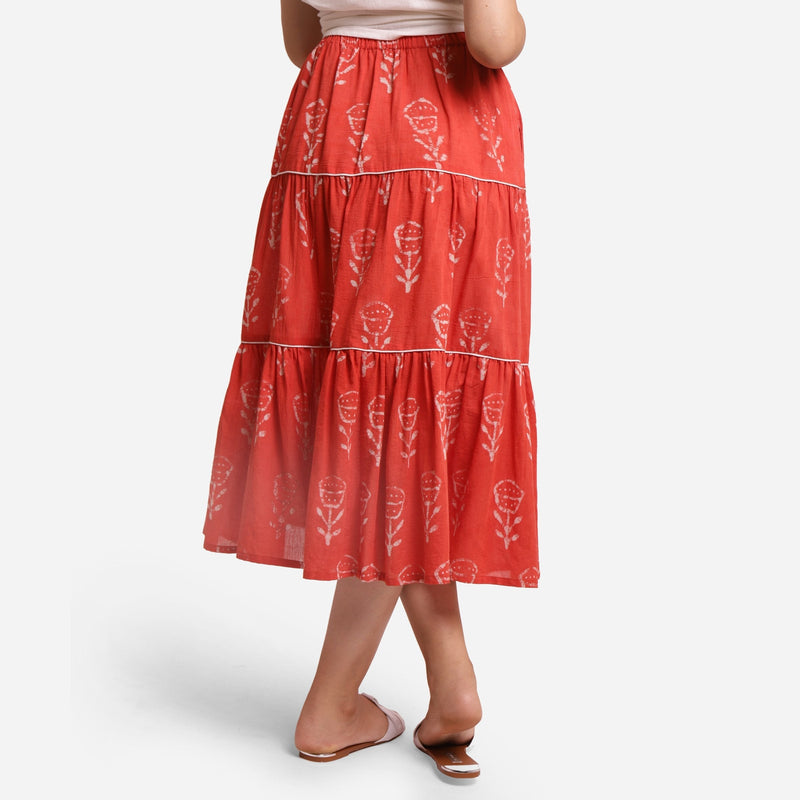 Back View of a Model wearing Orange Gathered Floral Maxi Skirt