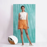 Front View of a Model wearing Orange Handspun Mirror Work Shorts