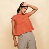 Front View of a Model wearing Orange Ruffled Neck 100% Cotton Flared Top