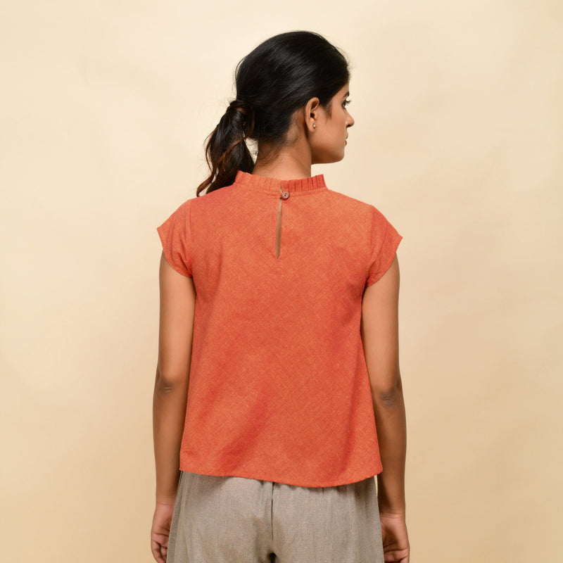 Back View of a Model wearing Orange Ruffled Neck 100% Cotton Flared Top
