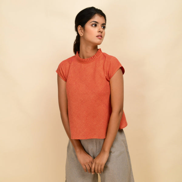 Front View of a Model wearing Orange Ruffled Neck 100% Cotton Flared Top
