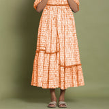 Front Detail of a Model wearing Orange Shibori Asymmetrical Tier Maxi Dress
