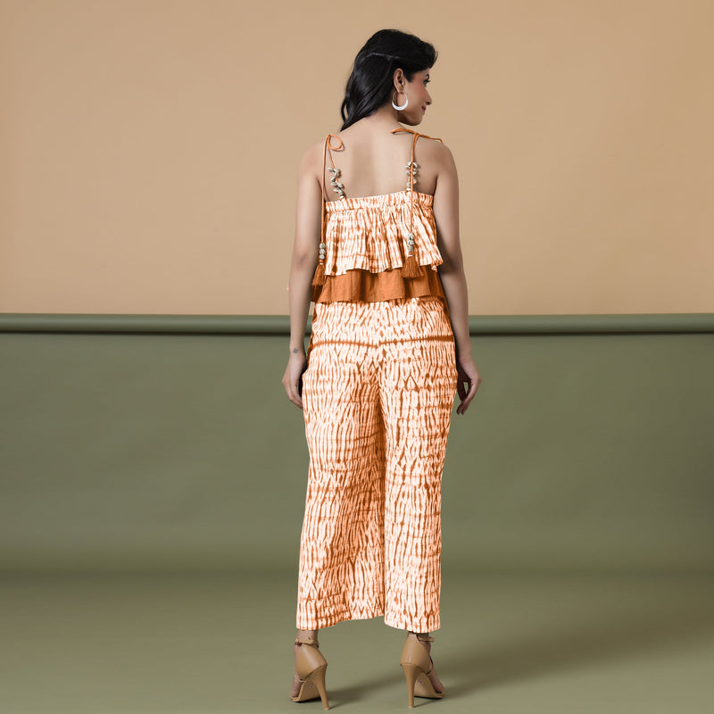 Back View of a Model wearing Orange Shibori Frilled Camisole Jumpsuit