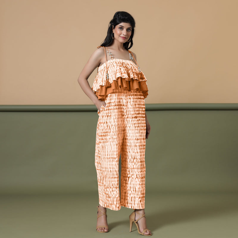Right View of a Model wearing Orange Shibori Frilled Camisole Jumpsuit