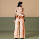 Back View of a Model wearing Orange Shibori Top and Wide-Legged Pant Set