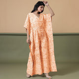 Right View of a Model wearing Orange Shibori V-Neck Kaftan Jumpsuit