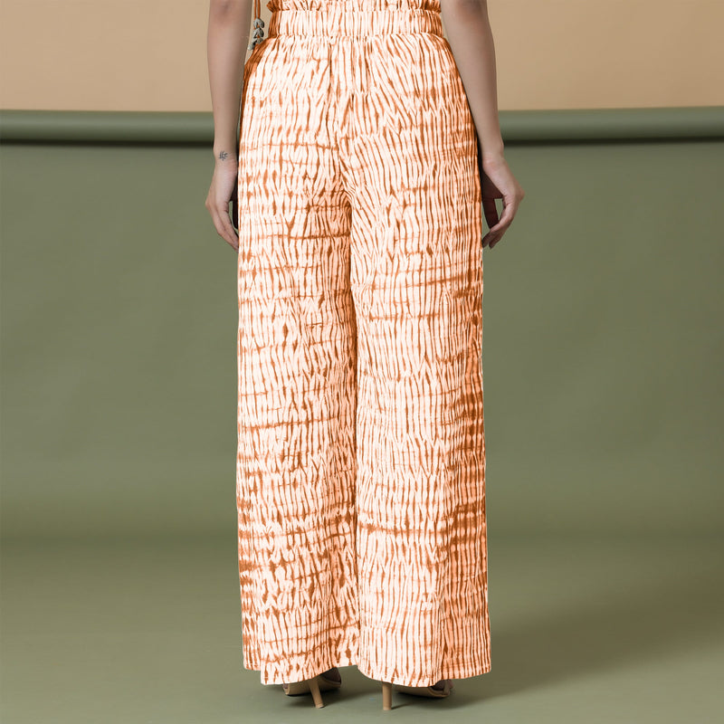Back View of a Model wearing Orange Shibori Wide Legged Cotton Pant