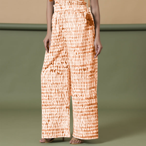Left View of a Model wearing Orange Shibori Wide Legged Cotton Pant