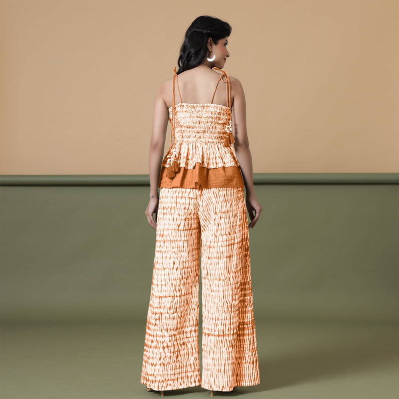 Back View of a Model wearing Orange Shibori Wide Legged Cotton Pant