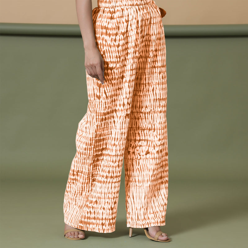 Right View of a Model wearing Orange Shibori Wide Legged Cotton Pant