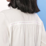 Back Detail of a Model wearing Organic Cotton Beaded Lace White Shirt