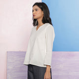 Left View of a Model wearing Organic Cotton Embroidered Split Neck Top