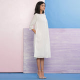 Right View of a Model wearing Organic Cotton White Beaded Shirt Dress