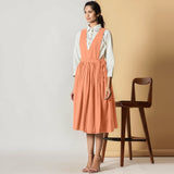 Left View of a Model wearing Peach Cotton Flax Pinafore Midi Wrap Dress