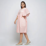 Left View of a Model wearing Peach Lined Cotton Chambray Dress