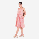 Left View of a Model wearing Peach Paisley Block Print Cotton Knee Length Dress