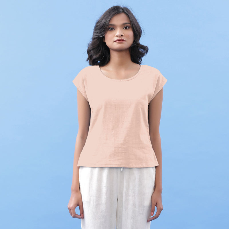 Front View of a Model wearing Peach Vegetable Dyed Handspun Cotton Essential Top