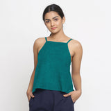 Front View of a Model wearing Solid Pine Green 100% Linen Relaxed Spaghetti Top