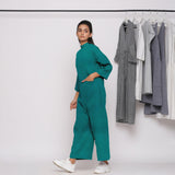 Left View of a Model wearing Pine Green 100% Linen Straight Jumpsuit