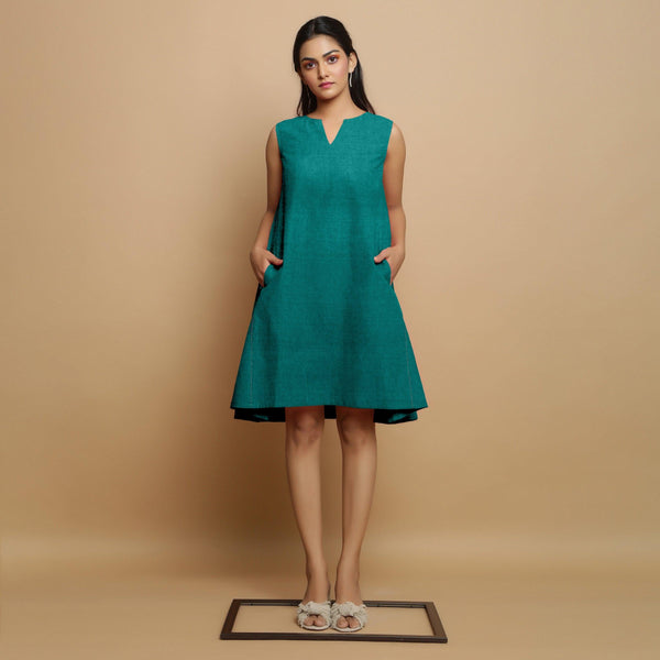 Front View of a Model wearing Pine Green Linen Hand Embroidered Knee-Length Godet Dress