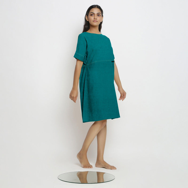 Right View of a Model wearing Pine Green 100% Linen Knee Length Yoked Dress