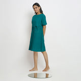 Left View of a Model wearing Pine Green 100% Linen Knee Length Yoked Dress