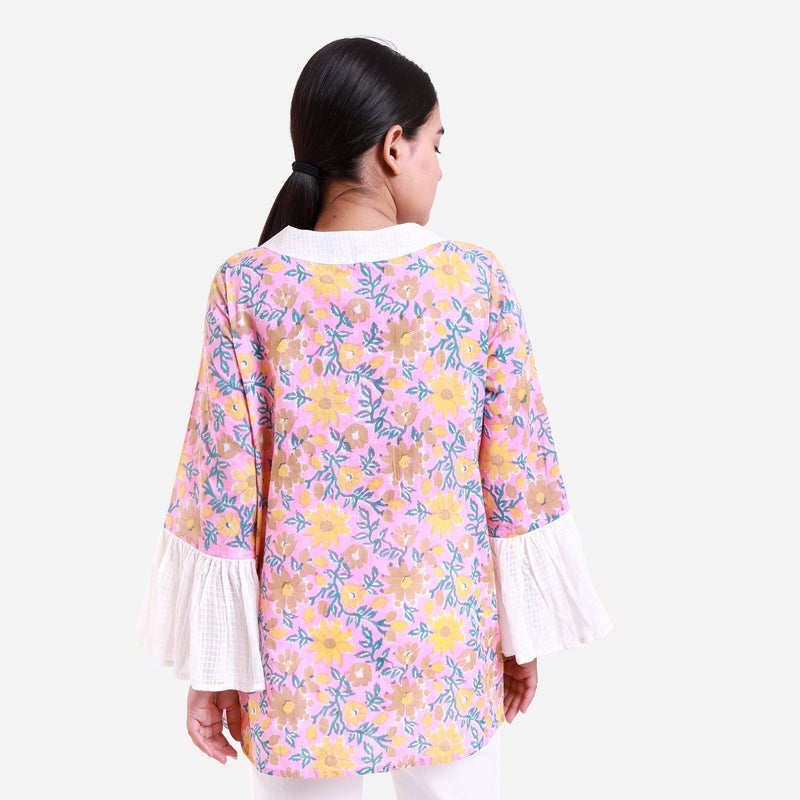 Back View of a Model wearing Pink Floral Block Print Frilled Sleeve Cotton Top