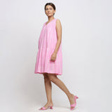 Left View of a Model wearing Pink Tie and Dye 100% Cotton Tiered V-Neck Short Dress
