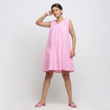 Front View of a Model wearing Pink Tie and Dye 100% Cotton Tiered V-Neck Short Dress