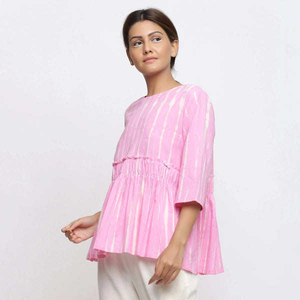 Left View of a Model wearing Pink Cotton Tie-Dye Cotton Gathered Flared Top