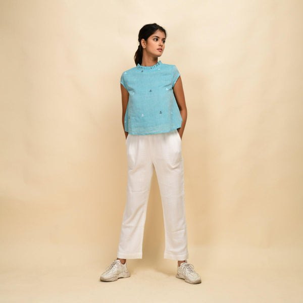 Front View of a Model wearing Powder Blue Top and Off-White Pant Set