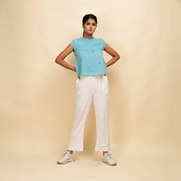 Front View of a Model wearing Powder Blue Top and Off-White Pant Set