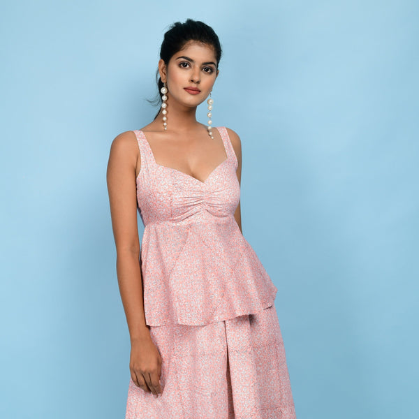 Front View of a Model wearing Powder Pink Block Printed Cotton Peplum Top