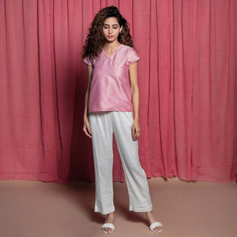 Front View of a Model wearing Powder Pink Cotton Chanderi Surplice Neck Top