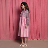 Left View of a Model wearing Powder Pink Cotton Block Printed Knee Length Frilled Dress
