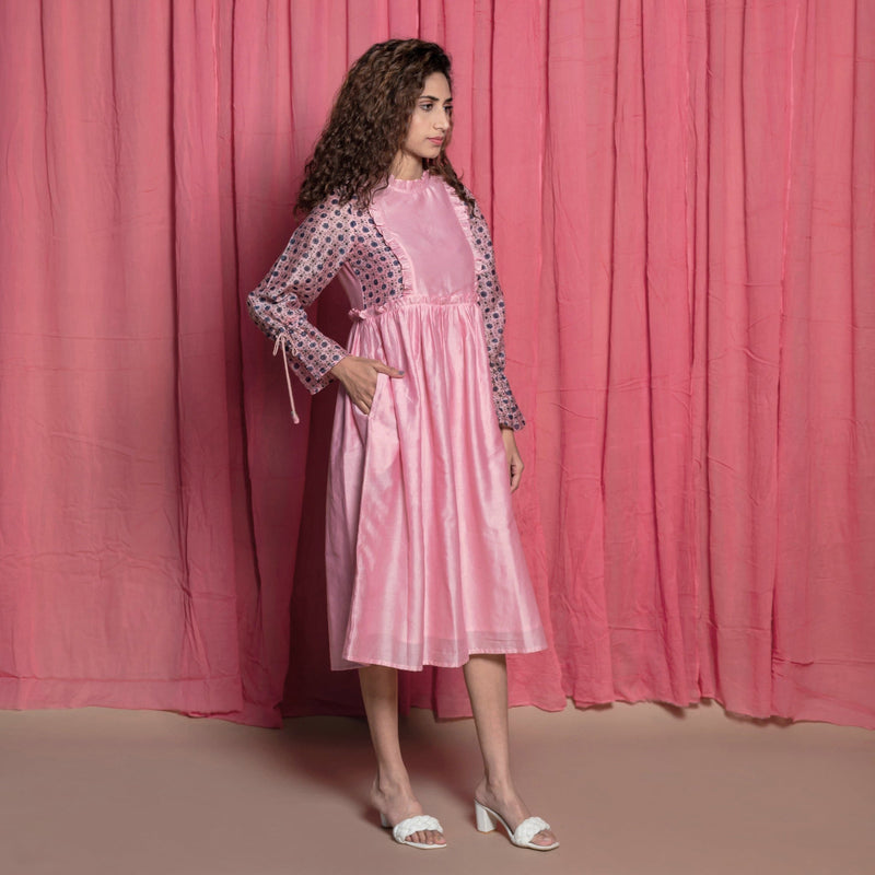 Right View of a Model wearing Powder Pink Cotton Block Printed Knee Length Frilled Dress