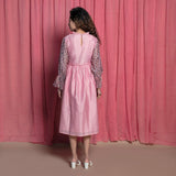 Back View of a Model wearing Powder Pink Cotton Block Printed Knee Length Frilled Dress