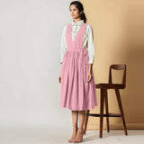 Left View of a Model wearing Powder Pink Cotton Flax Pinafore Midi Wrap Dress