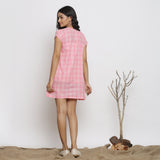 Back View of a Model wearing Powder Pink Checks Handspun Cotton Yoked Mini Dress
