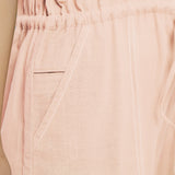 Close View of a Model wearing Powder Pink Vegetable Dyed Button-Down Jumpsuit
